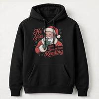 Humorous Bookworm Santa Hooded Sweatshirt, He Sees What You've Been Reading Hoodie, Christmas Book Lover Hoodie, Holiday Reader Graphic Sweater