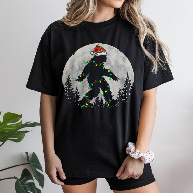 Santa Hat Sasquatch Fairy Lights Graphic Tee, Bigfoot Christmas T-Shirt, Humorous Cryptid Xmas Holiday T-Shirt, Festive Yeti Lover Top