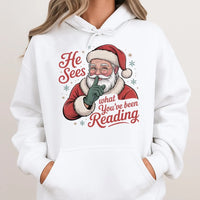 Humorous Bookworm Santa Hooded Sweatshirt, He Sees What You've Been Reading Hoodie, Christmas Book Lover Hoodie, Holiday Reader Graphic Sweater