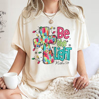 Christmas Cross T-Shirt, Be the Light Christian Shirt, Faith Inspired Holiday Tee, Bible Verse Graphic Shirt, Xmas Present for Women and Men